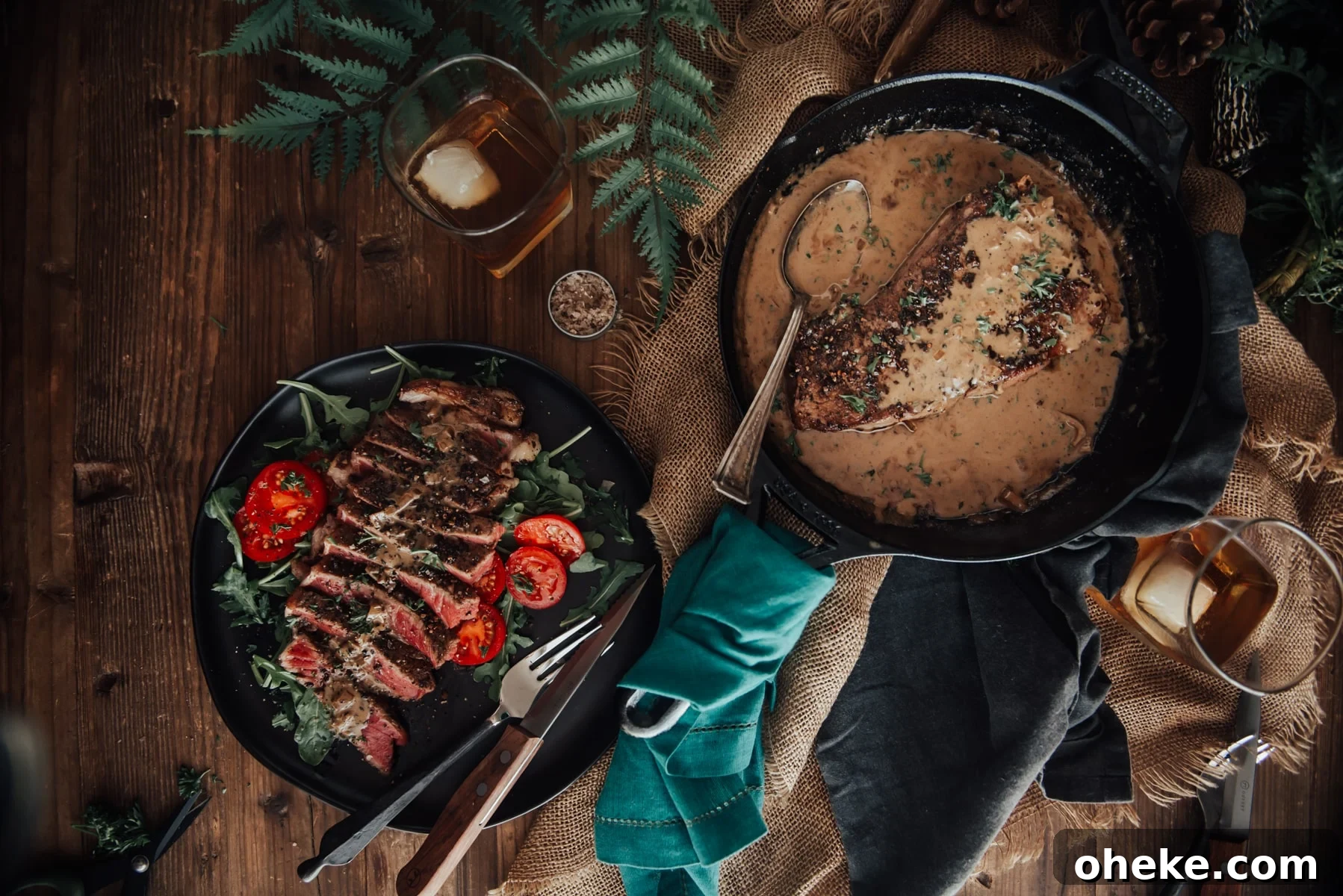 Overhead shot of steak in skillet with sauce and steak sliced on plate.