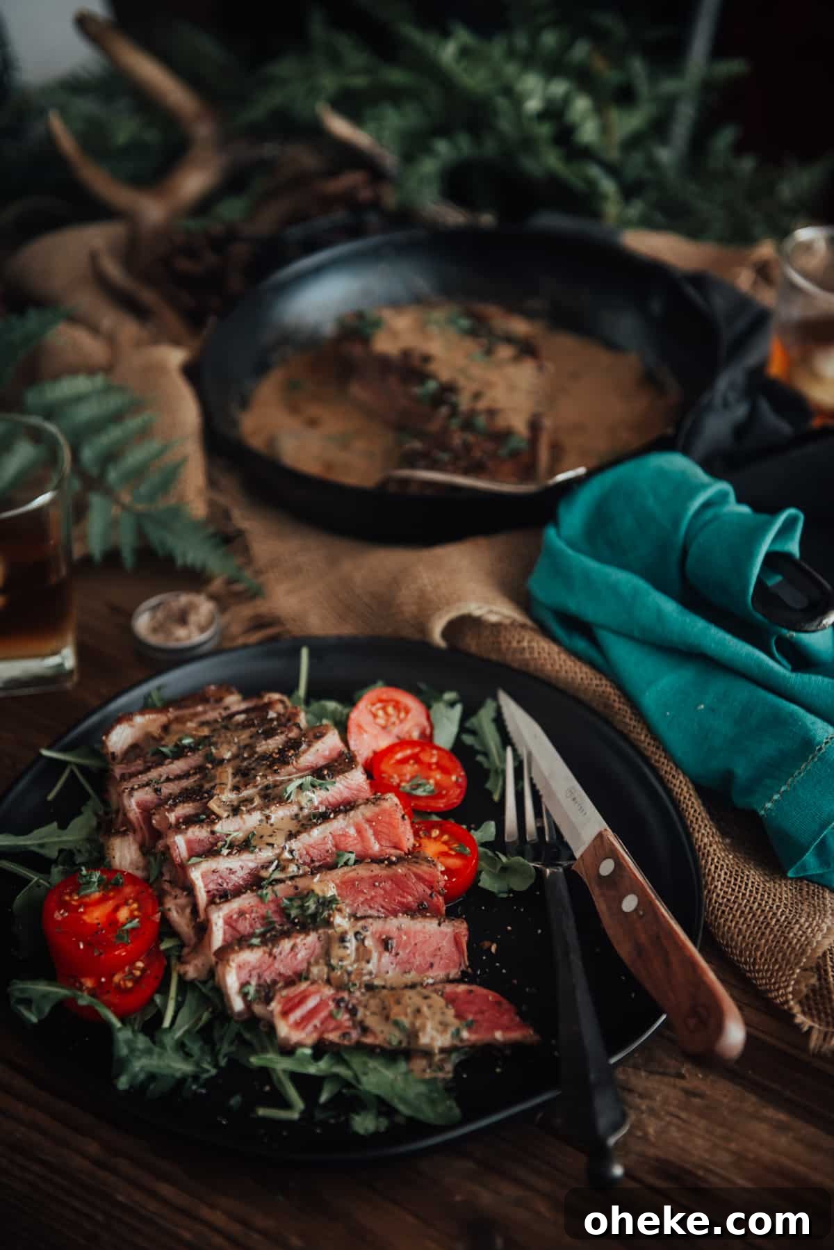 Showing a rare steak sliced on a plate with sauce atop.