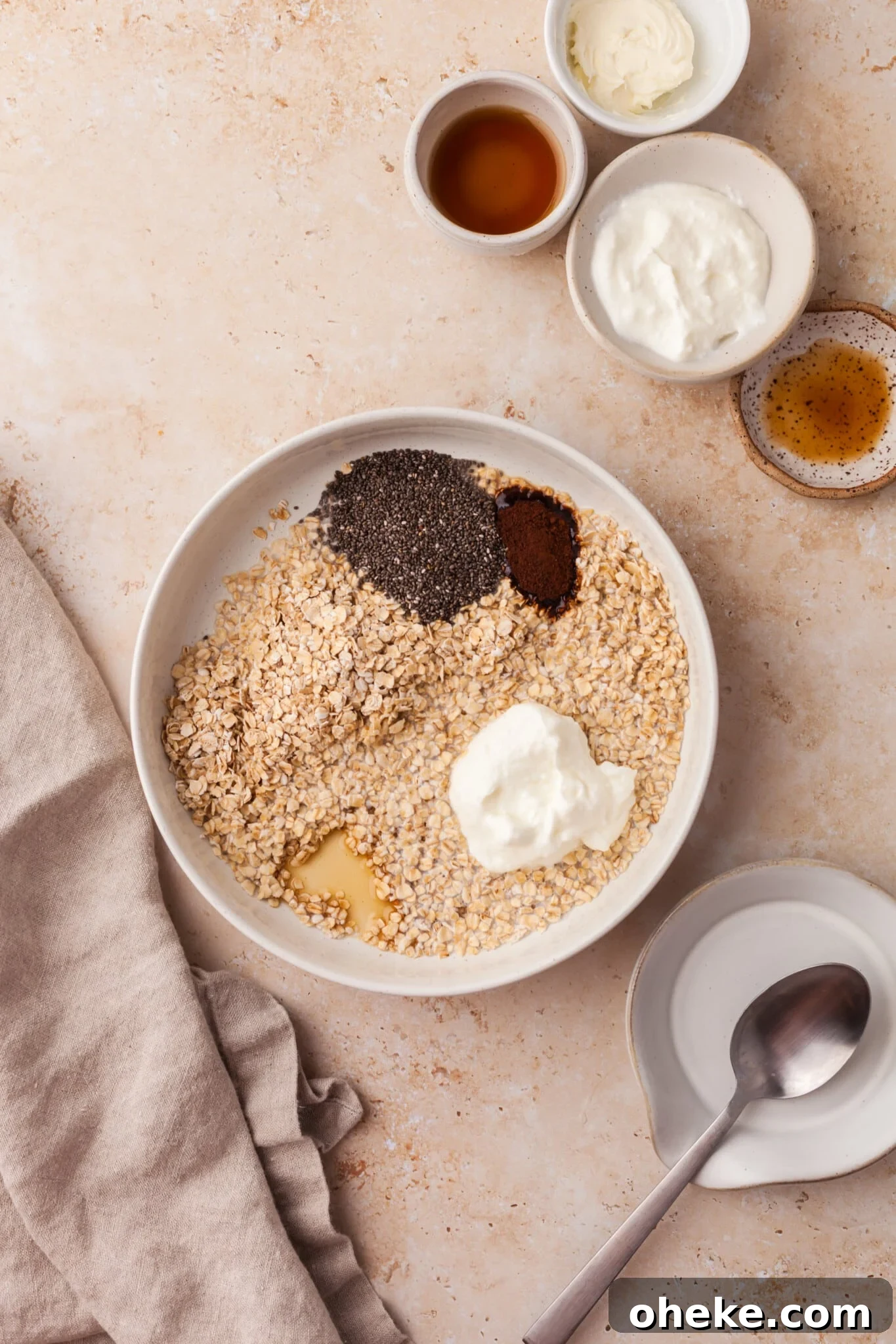 Based on the Italian coffee-infused dessert, these tiramisu overnight oats are a delicious, surprisingly nutritious way to start the day. Combining oats, Greek yogurt, milk, chia seeds, instant coffee, and maple syrup in a bowl.