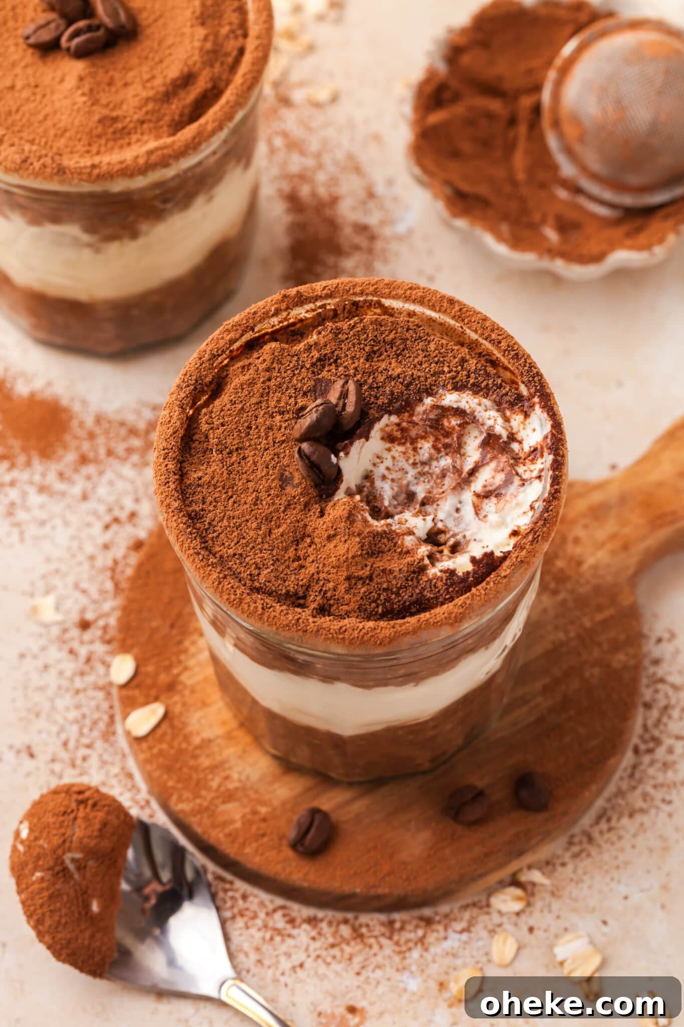 Based on the Italian coffee-infused dessert, these tiramisu overnight oats are a delicious, surprisingly nutritious way to start the day. A jar of tiramisu overnight oats with a bite taken out of it.