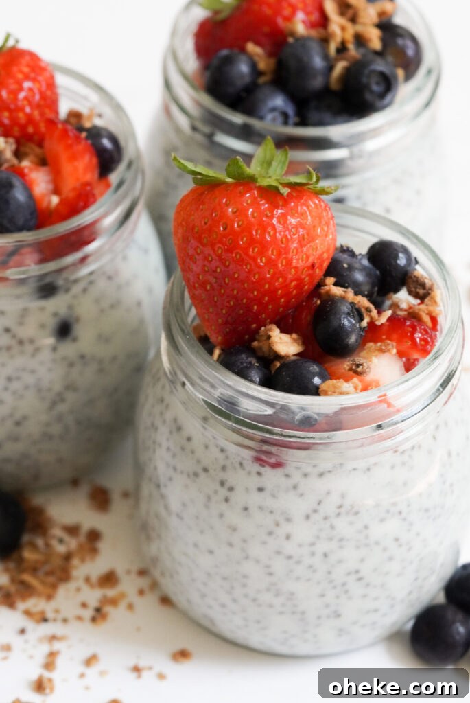 High-Protein Chia Pudding Recipe for Muscle Fuel 10 pre-portioned protein chia seed pudding jars topped with berries, granola, and honey.