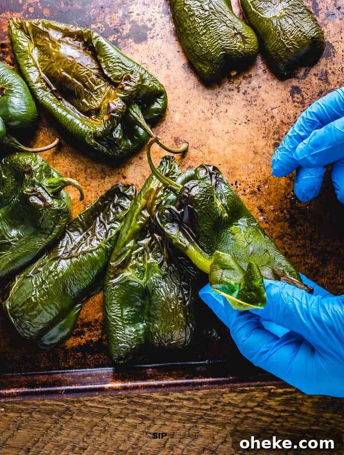 Roasted poblano peppers being peeled.