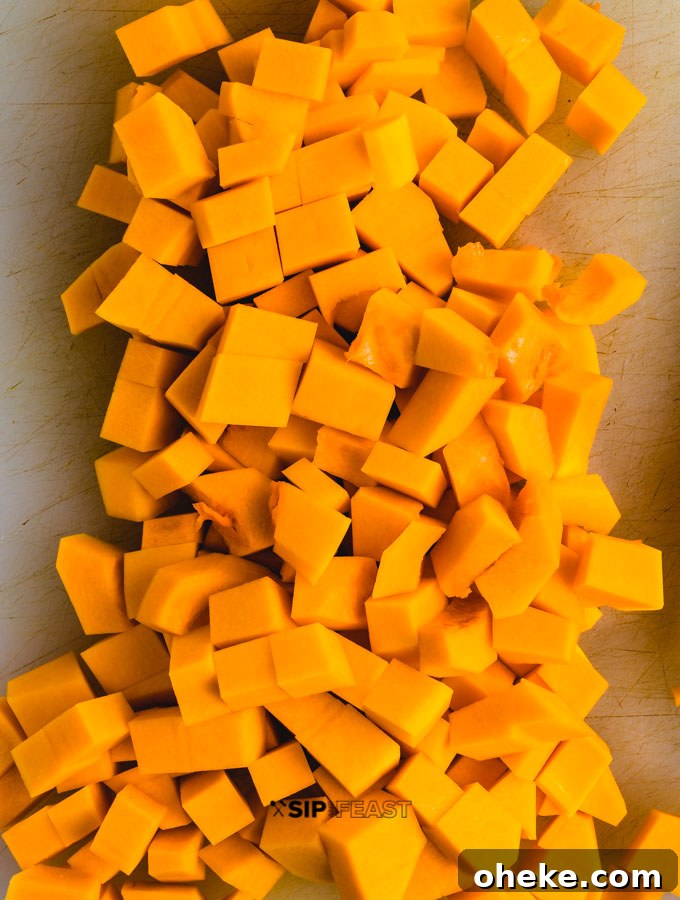 Chopped butternut squash on cutting board.