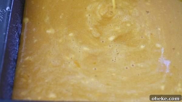 Paleo Lemon Bars with Almond-Coconut Crust Recipe 7 Pouring the lemon mixture over the crust in the pan.