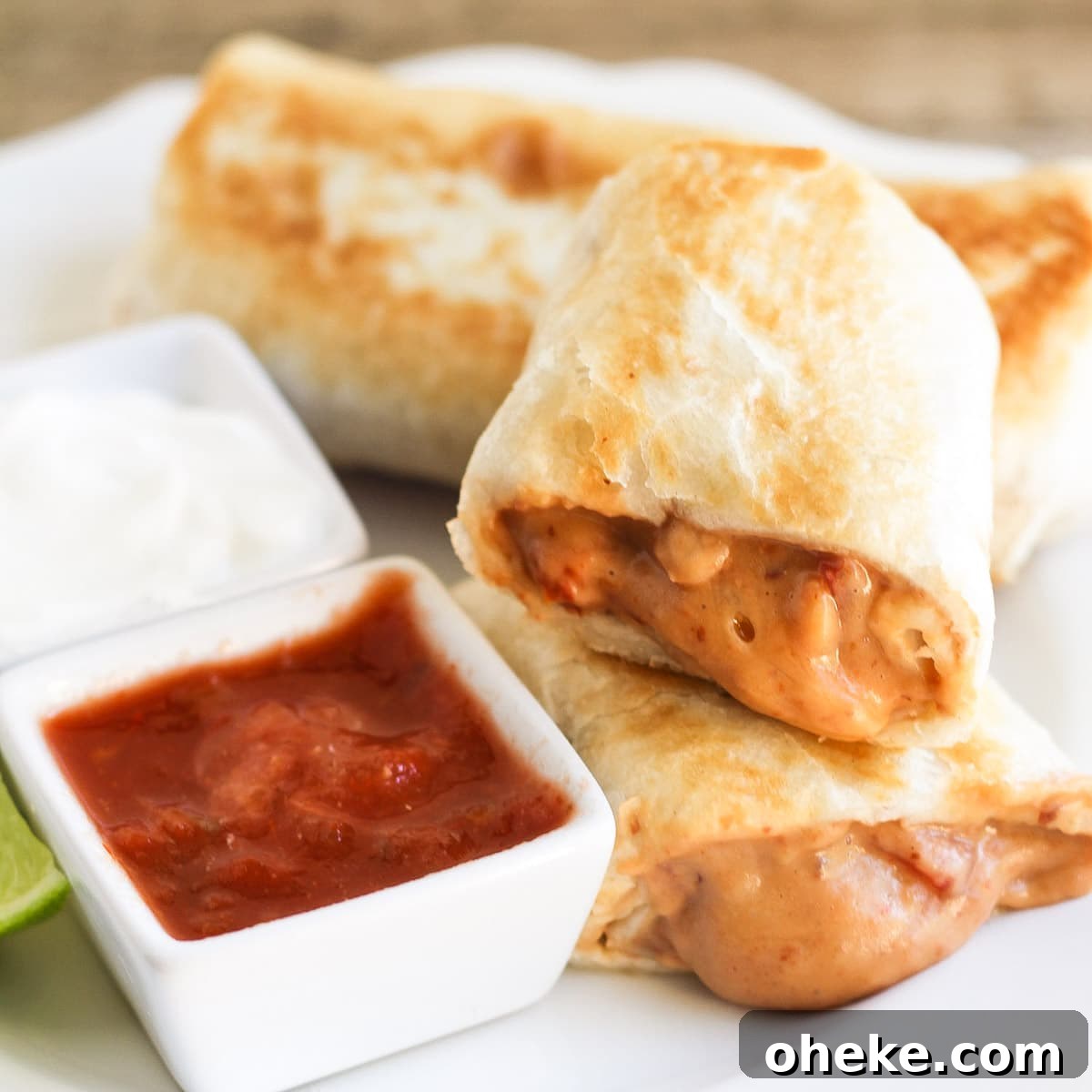 Easy and delicious Bean Chimichangas are filled with beans, cheese and ROTEL and they taste just like the ones at the restaurants! Bean chimichanga cut in half and served with salsa