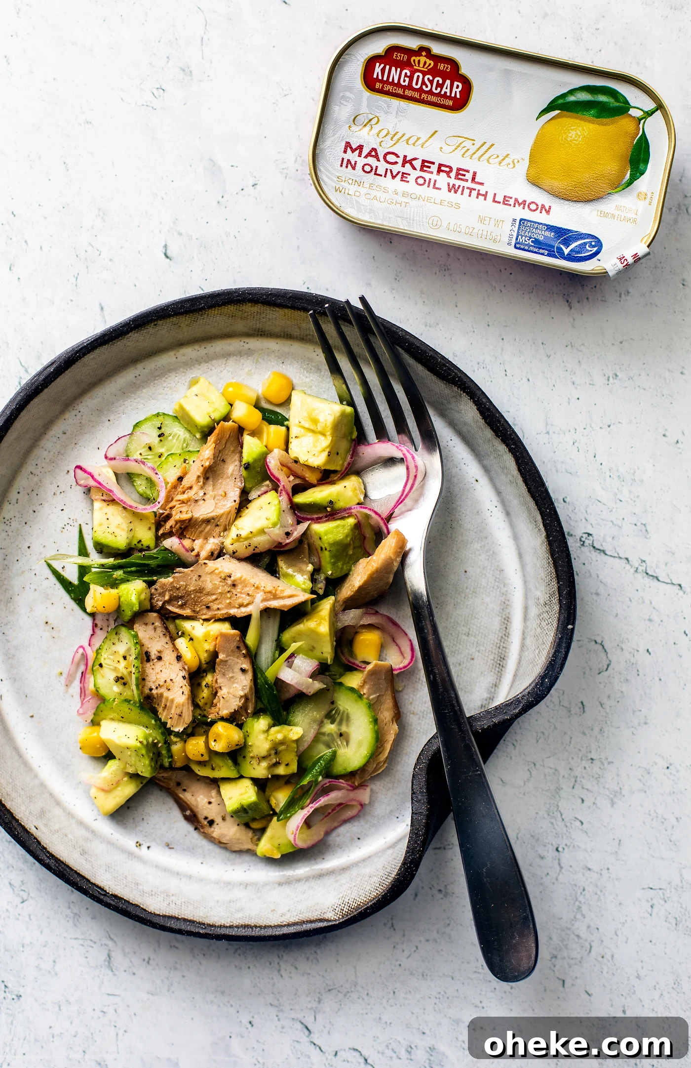 Citrus Avocado Mackerel Salad with Herb Vinaigrette 3 Overhead shot of plate of avocado and mackerel salad with a tin of lemon mackerel next to it.
