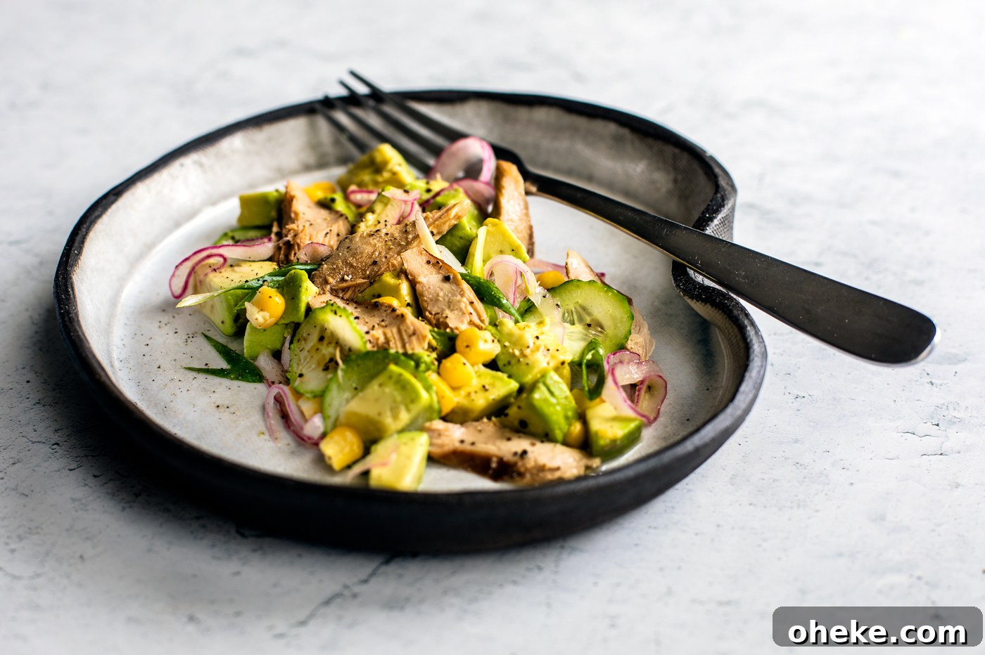 Citrus Avocado Mackerel Salad with Herb Vinaigrette 4 Close up side shot of avocado and mackerel salad on a plate.