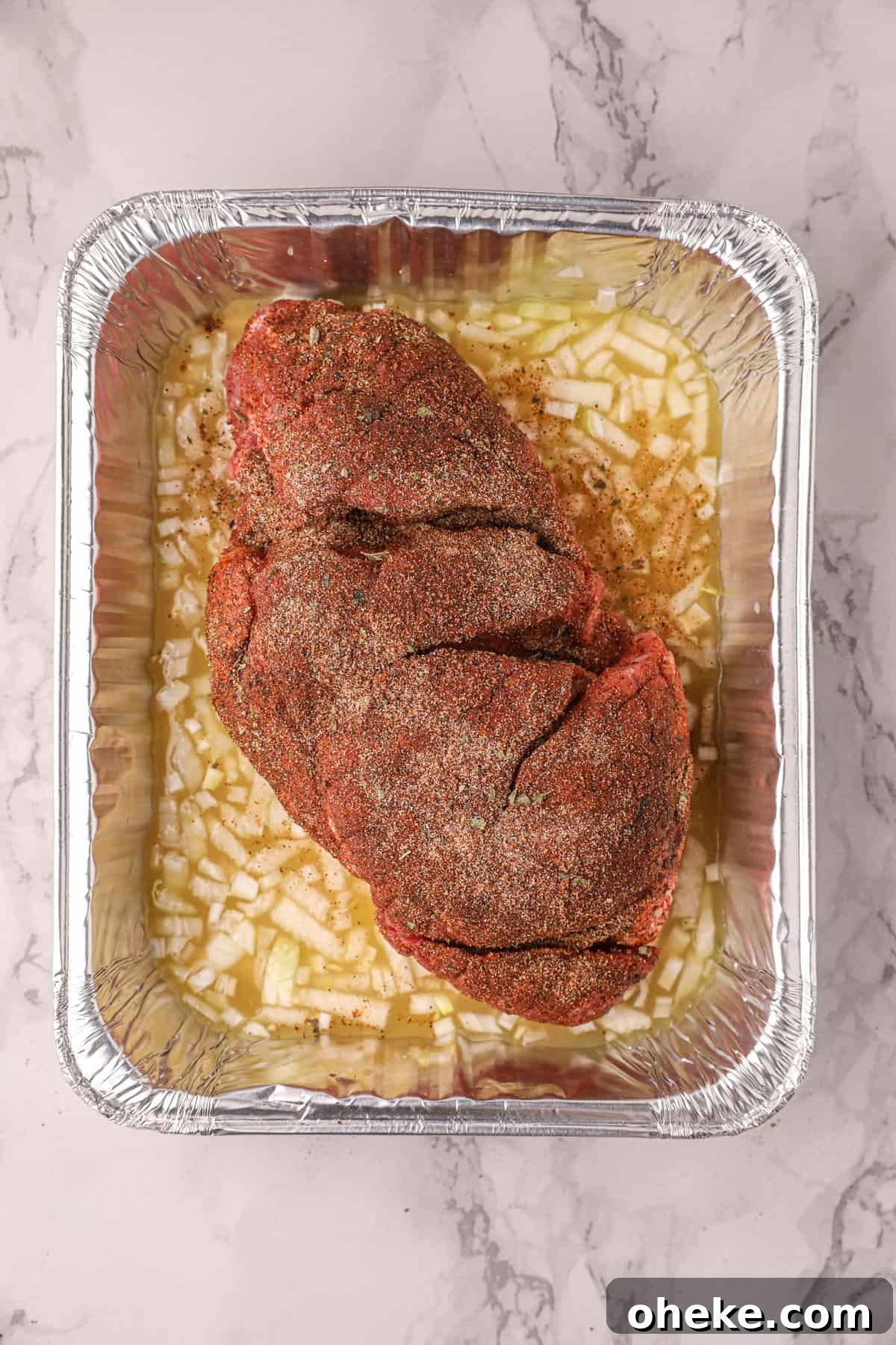 Adding Seasoned Pork to Seasoning in Tin for Smoked Pork Carnitas