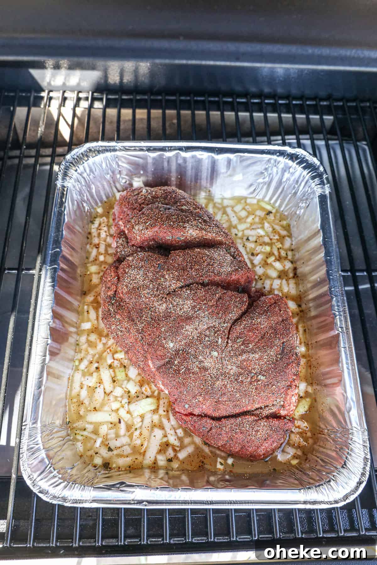 Placing Tin on Pellet Grill for Smoked Pork Carnitas Recipe