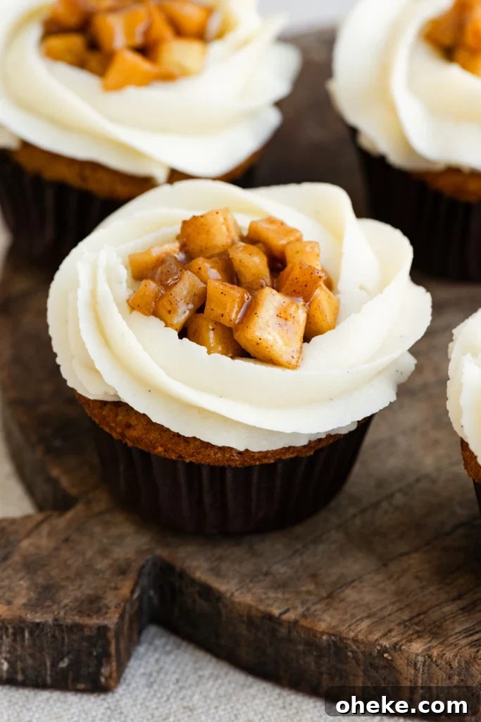 Apple Pie Cupcakes Recipe with Cinnamon Streusel 2 Close up of vanilla frosted cupcakes filled with apple pie filling.