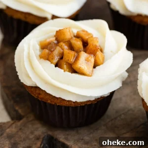 Apple Pie Cupcakes Recipe with Cinnamon Streusel 6 Close up of vanilla frosted cupcakes filled with apple pie filling.
