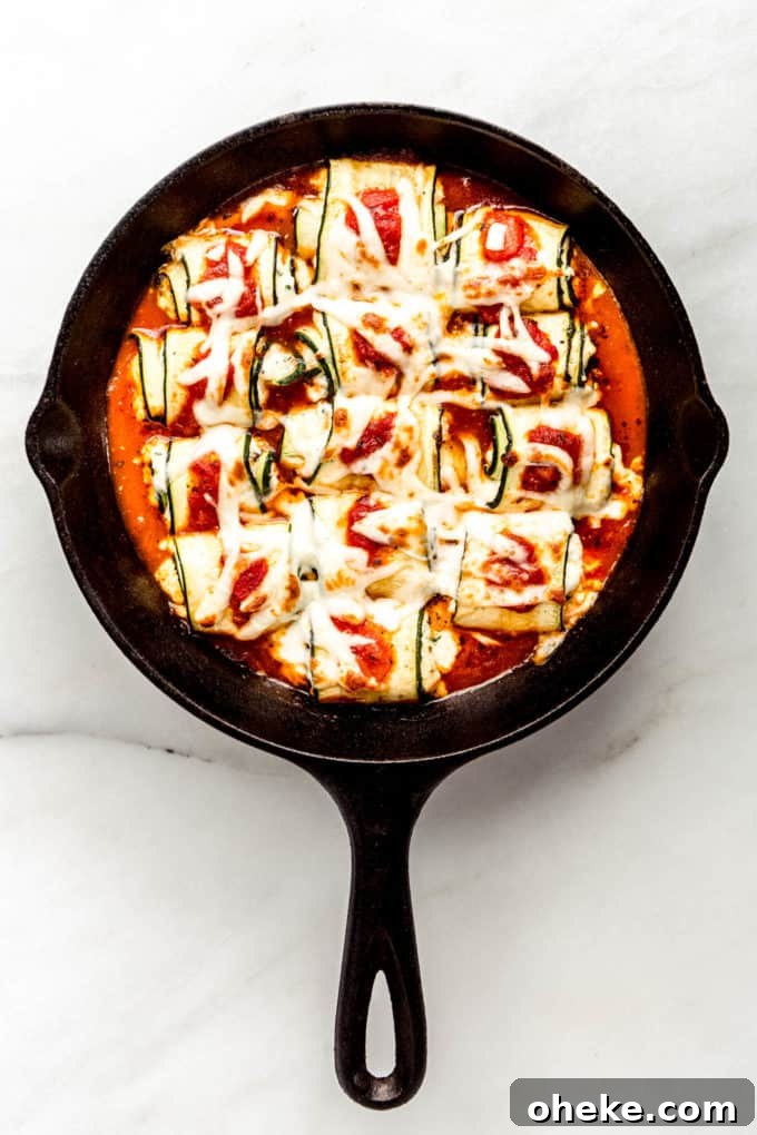 Ricotta-Stuffed Zucchini Involtini with Parmesan and Herbs 9 Zucchini roll ups in a cast iron skillet