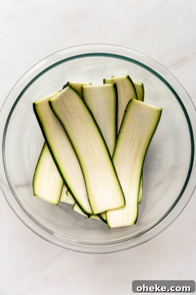 Ricotta-Stuffed Zucchini Involtini with Parmesan and Herbs 3 Slices of zucchini in a clear mixing bowl