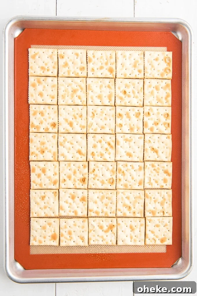 saltine crackers on baking sheet