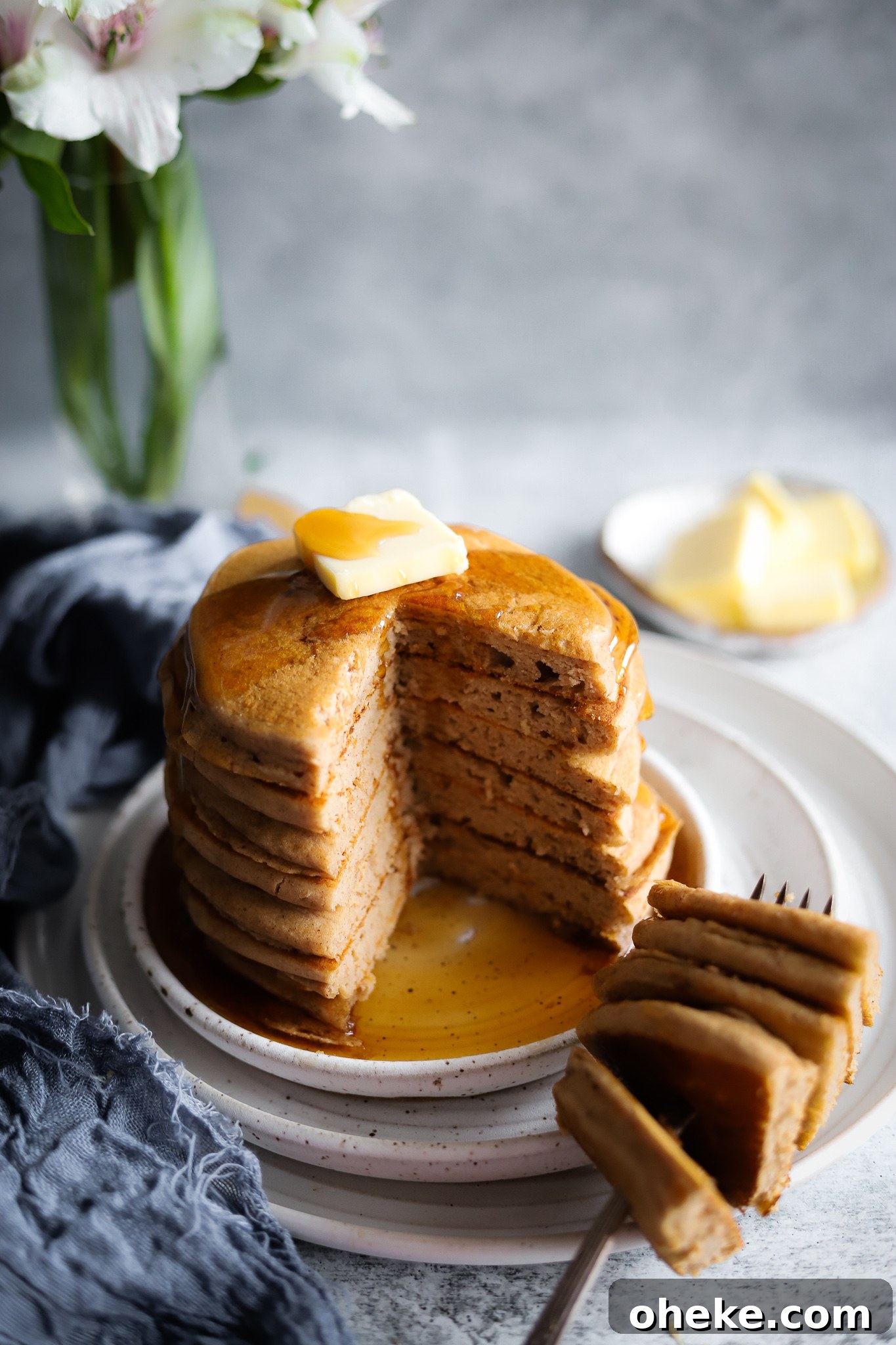 Stack of pancakes with strawberries on top.