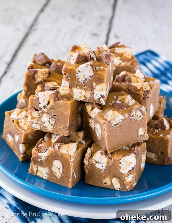 Salted Caramel Snickers Fudge - adding candy bar chunks and sea salt makes this caramel fudge an irresistible recipe!