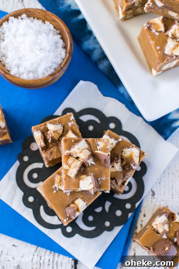 Salted Caramel Snickers Fudge - this easy fudge is filled with candy bar chunks and sea salt. Great no bake recipe for hot summer days!