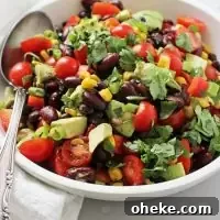 This easy and healthy Mexican bean salad is fantastic for picnics and potlucks! Packed with two kinds of beans, crunchy veggies, creamy avocado and a dreamy lime chipotle dressing. Gluten and dairy free, with a vegan option included!