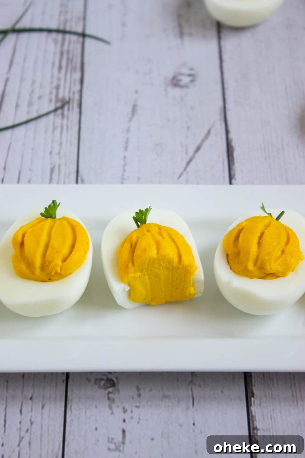Pumpkin-Spiced Deviled Eggs for Low-Carb Fall Brunch 14 bite taken out of deviled eggs