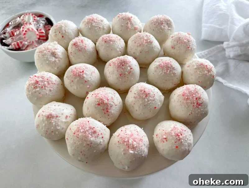 peppermint cake pops on a cake stand.