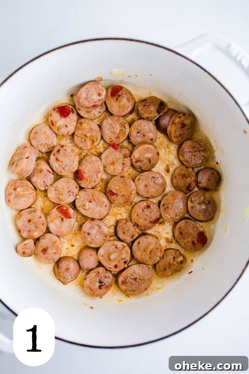 Sliced sausage in a large white pot.