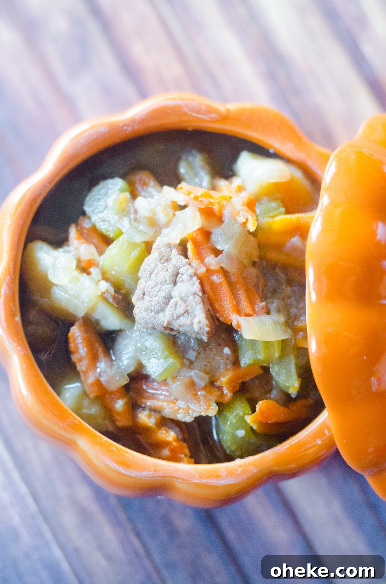 Instant Pot Beef Stew in an orange pumpkin shaped bowl with lid