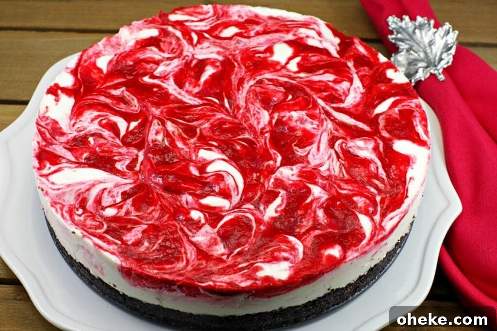 Whole no bake strawberry rhubarb cheesecake on a plate