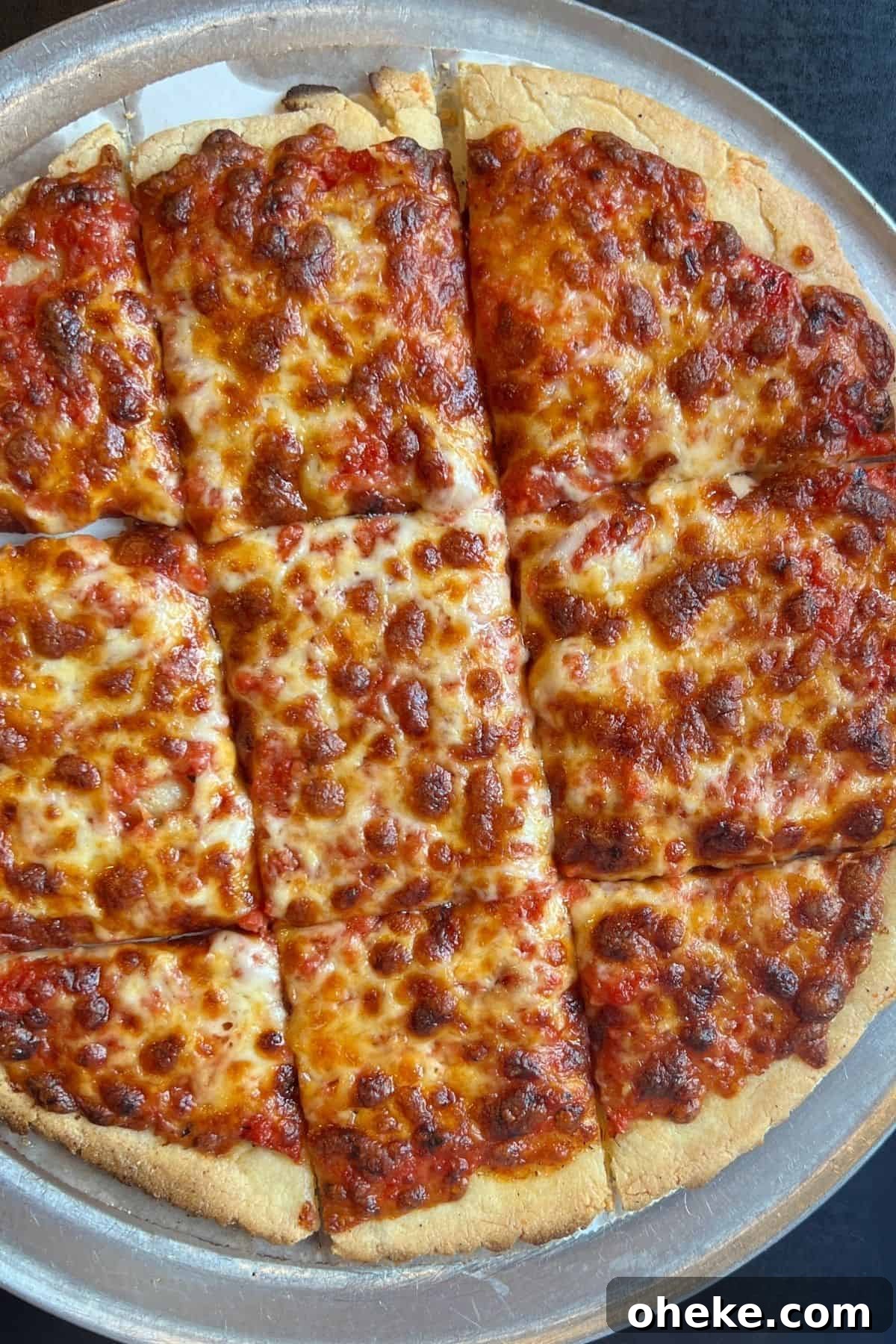 A large cheese pizza that's golden brown.