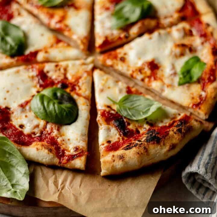Gluten-free pizza cooked in an Ooni pizza oven with perfectly charred crust, garnished with basil.