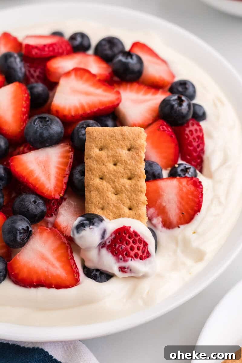 using a graham cracker to eat the dip.