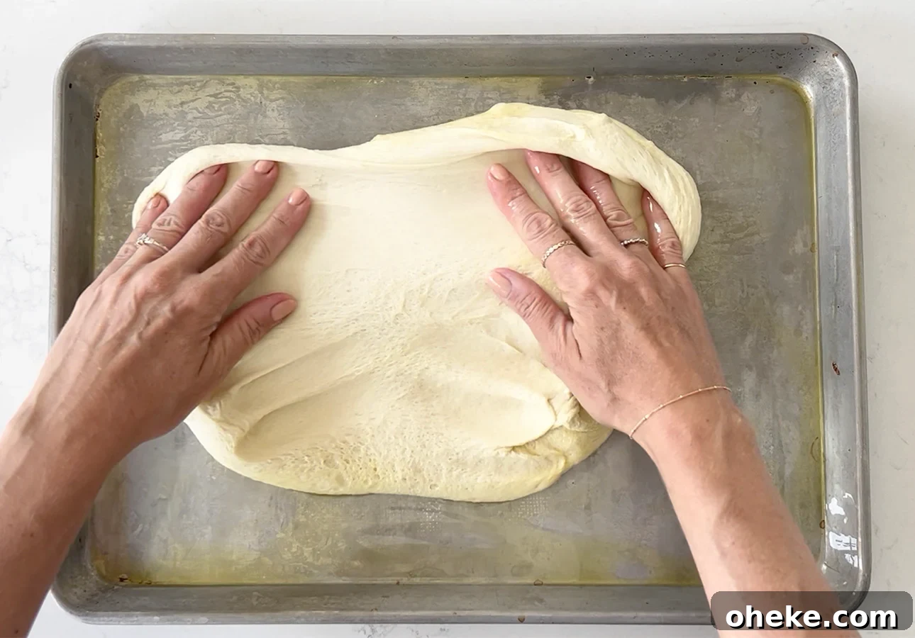 Pissaladière: French Onion and Anchovy Tart Recipe (Video) 11 Spreading dough to make pissaladière