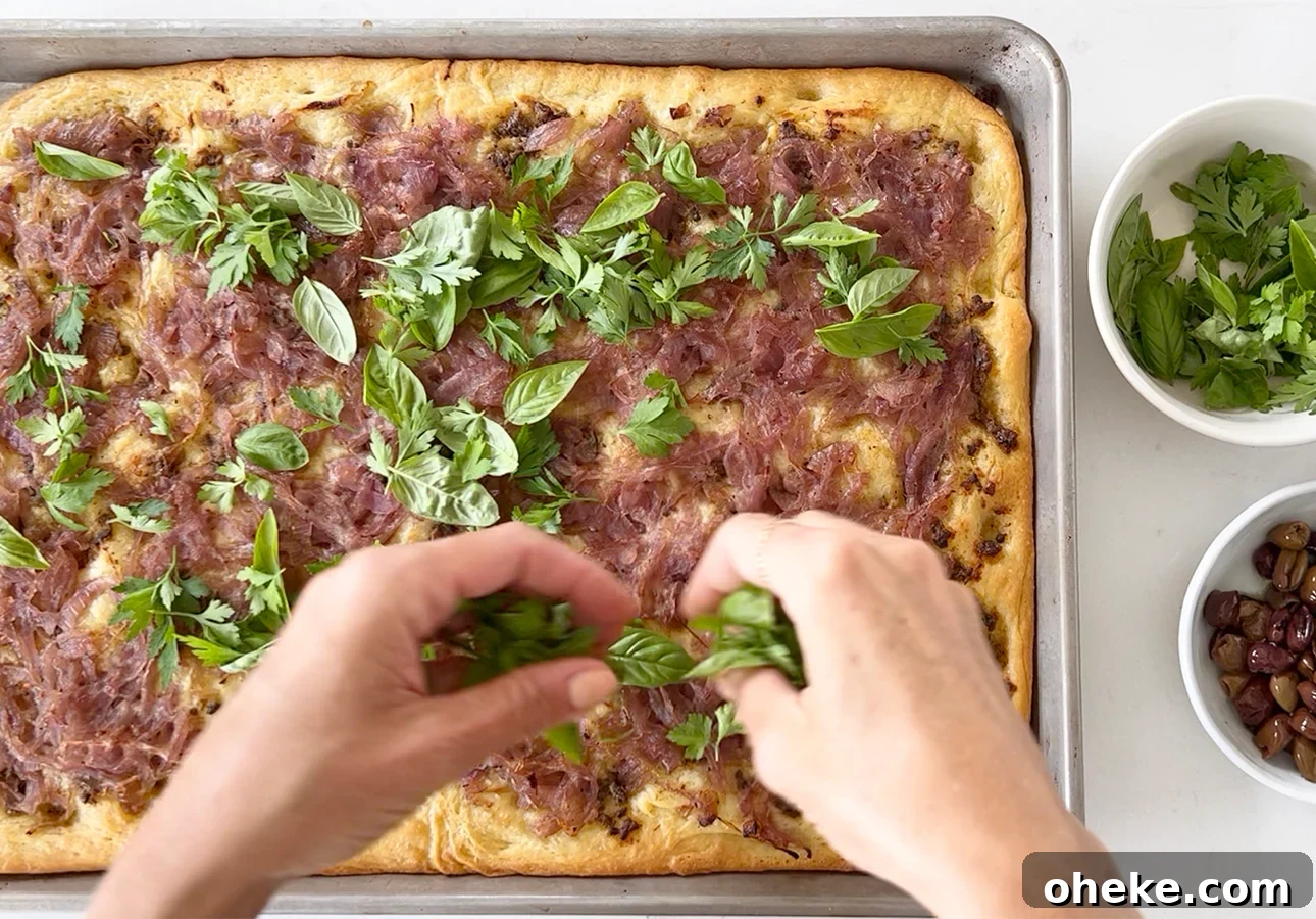 Pissaladière: French Onion and Anchovy Tart Recipe (Video) 7 Garnishing Provençal flatbread with Niçoise olives and fresh herbs