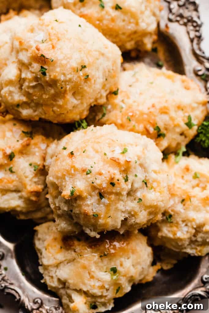 A close-up of the golden drop biscuits, brushed with butter and sprinkled with parsley.