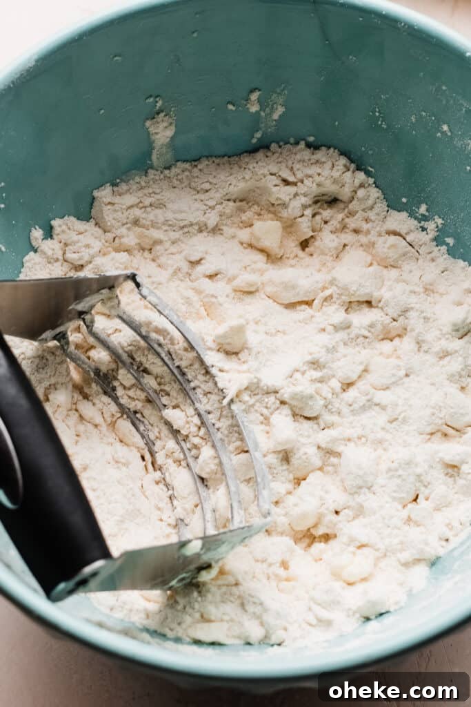 A bowl of the butter cut into the flour mixture.
