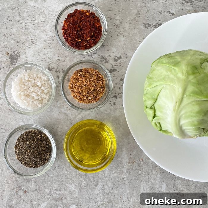 Crispy Roasted Cabbage Steaks with Garlic and Parmesan 3 cabbage on a plate and spices in single bowls on a marble counter