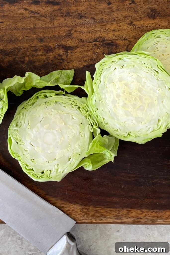 Crispy Roasted Cabbage Steaks with Garlic and Parmesan 4 sliced cabbage steaks on a wooden cutting board