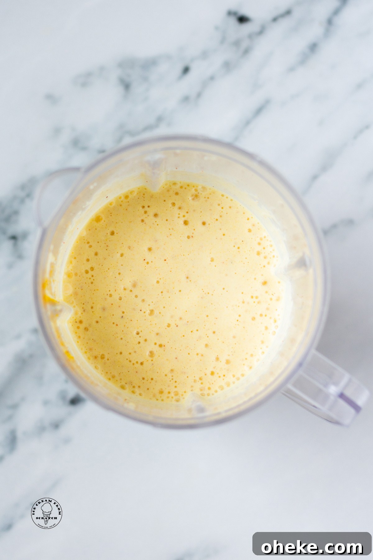 Overhead view of a pineapple milkshake in a blender jar