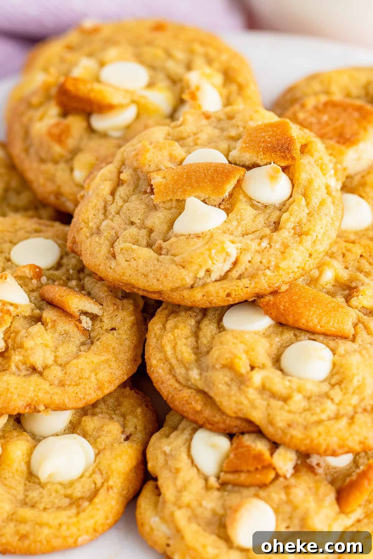 up close stacked banana pudding cookies on white plate