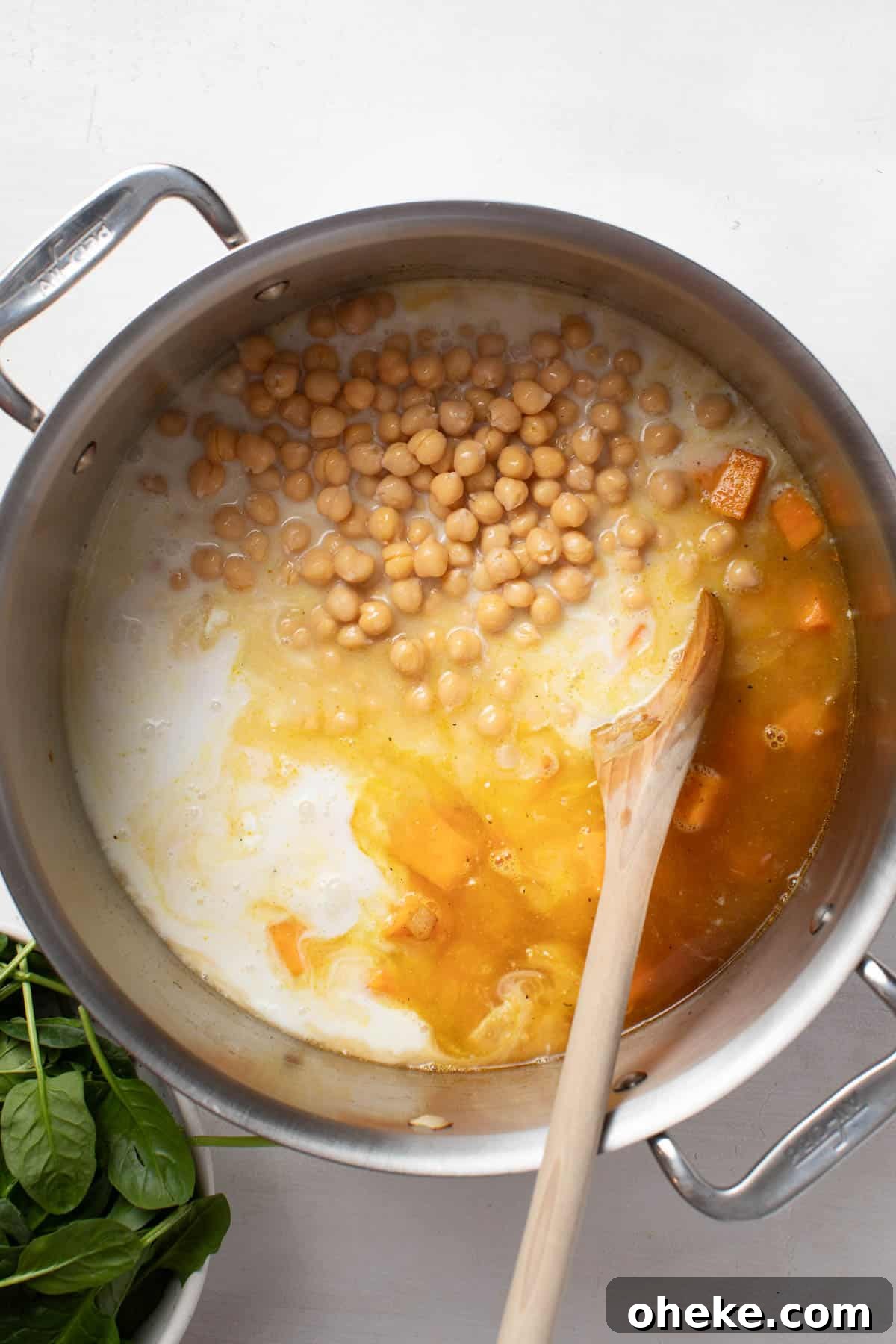 Turmeric Ginger Chickpea Stew to Reduce Inflammation 6 Adding coconut milk into the stew with chickpeas.