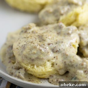Half a biscuit smothered in sawmill gravy with pork sausage and topped with black pepper