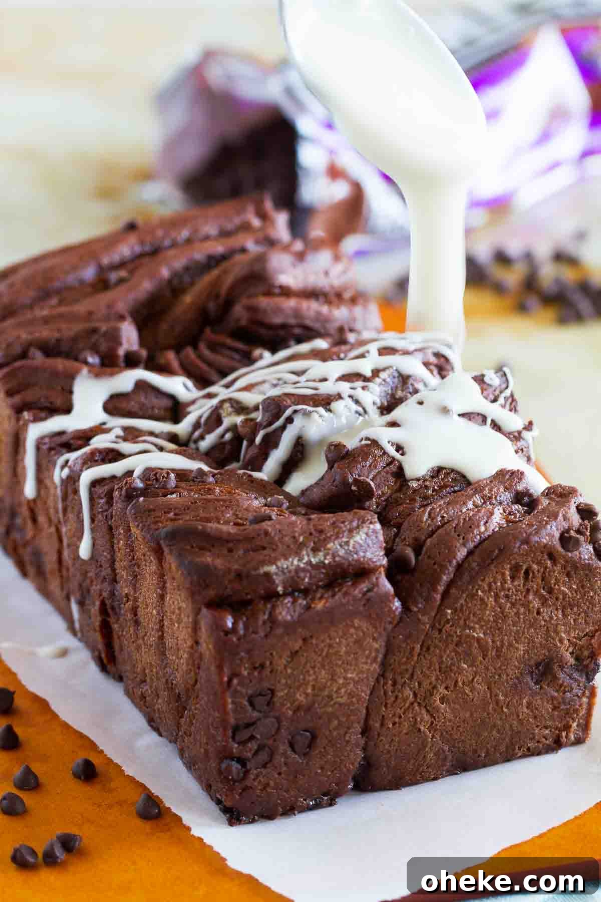 Decadent Chocolate Pull-Apart Bread Recipe 4 Drizzling icing over chocolate pull apart bread.