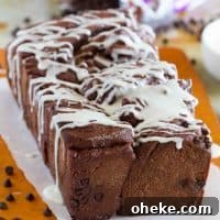 Decadent Chocolate Pull-Apart Bread Recipe 7 Loaf of chocolate pull apart bread drizzled with icing.