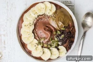 Thick Dreamy Chocolate Smoothie Bowl Recipe for Breakfast 12 A thick chocolate smoothie topped with fresh fruit, seeds, and nut butter.