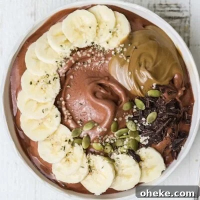 Thick Dreamy Chocolate Smoothie Bowl Recipe for Breakfast 9 A thick chocolate smoothie topped with fresh fruit, seeds, and nut butter.