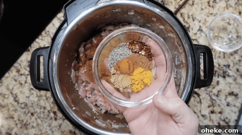 Adding spices to pot.