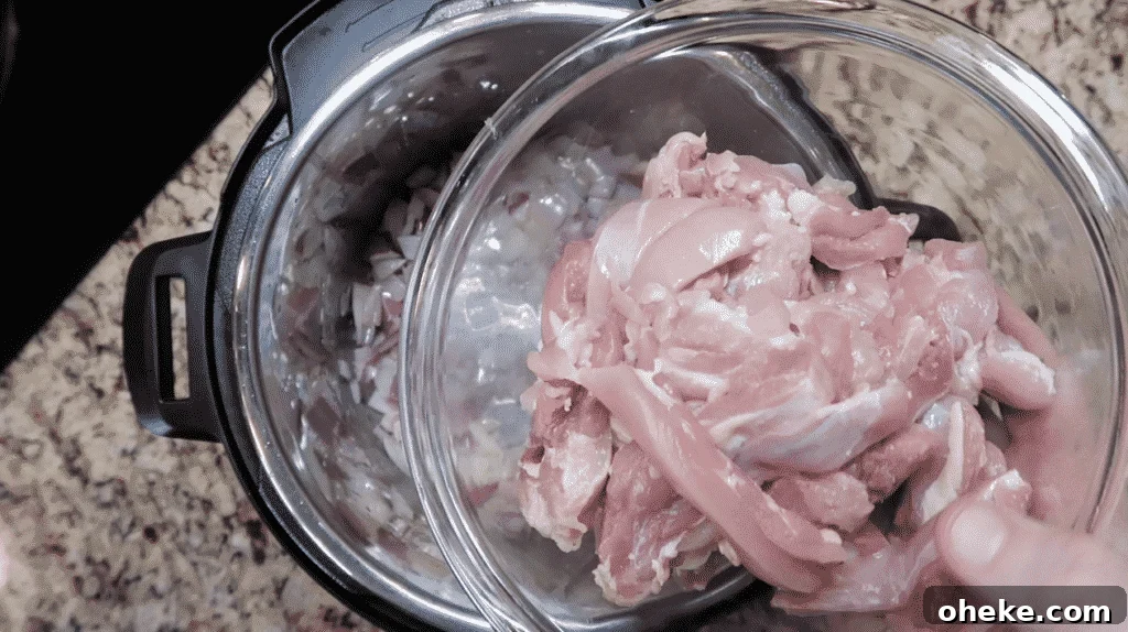 Adding sliced chicken thighs to pot