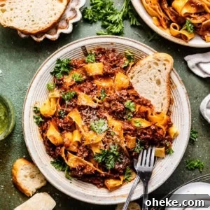 Short Rib Bolognese Recipe: Slow-Simmered, Rich Italian Ragu 17 short rib bolognese in a bowl with bread and a fork.
