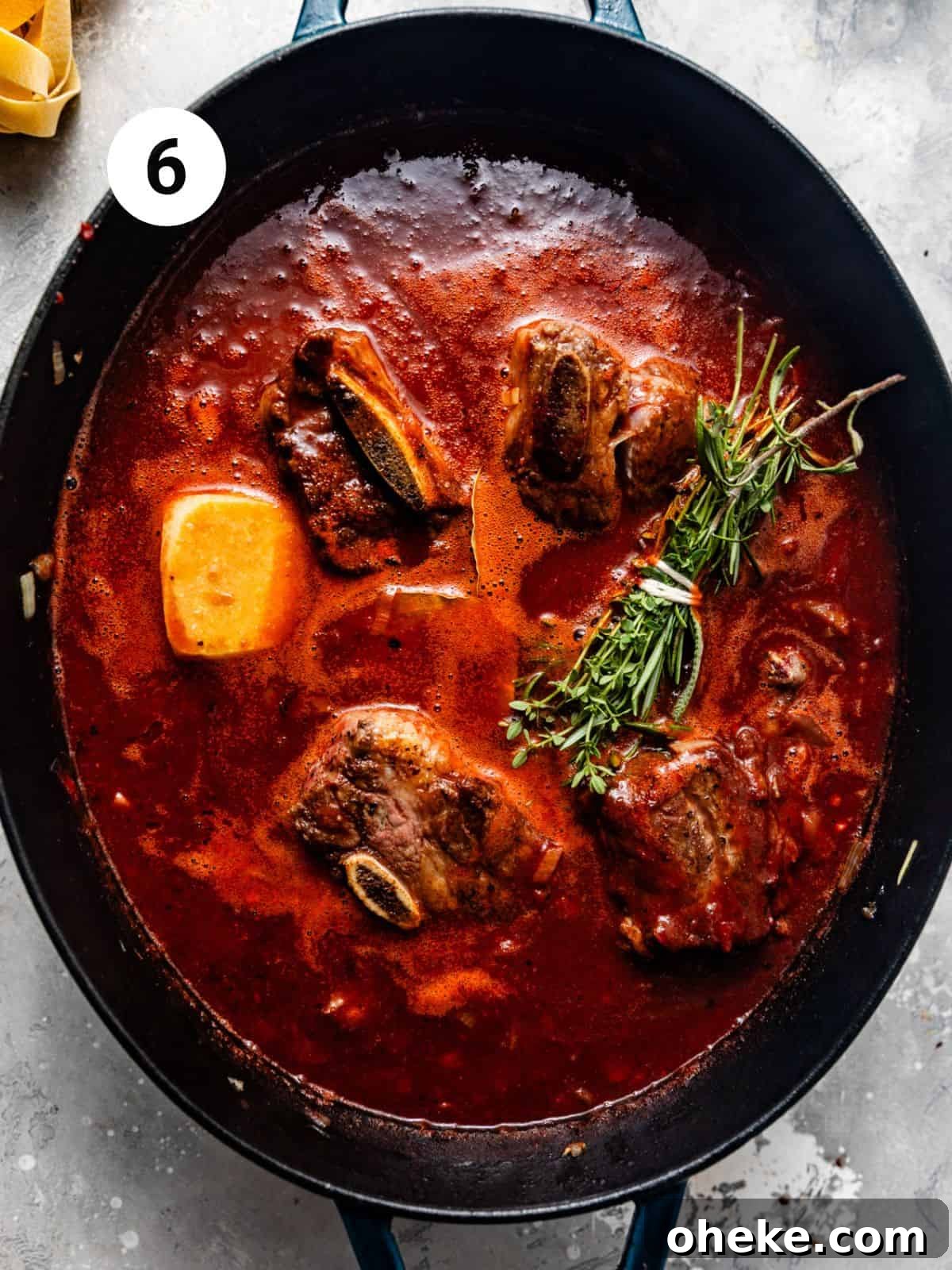 Short Rib Bolognese Recipe: Slow-Simmered, Rich Italian Ragu 9 short ribs, fresh herbs, and a parmesan rind simmering in a large pot.