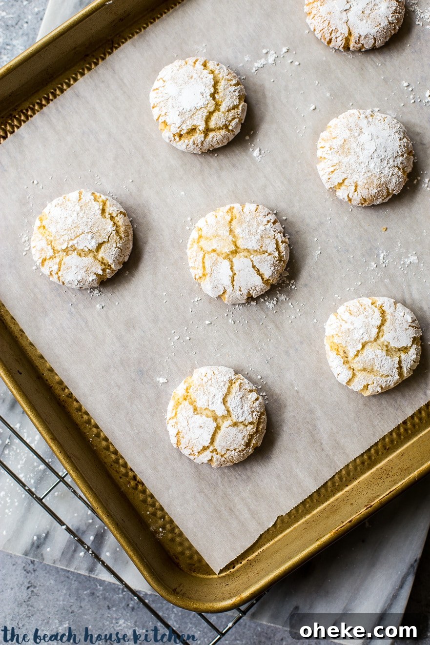 Classic Italian Amaretti Cookies Recipe — Crispy, Almond-Flavored Treats 4 Overhead photo of amaretti cookies on a cookie sheet lined with parchment paper