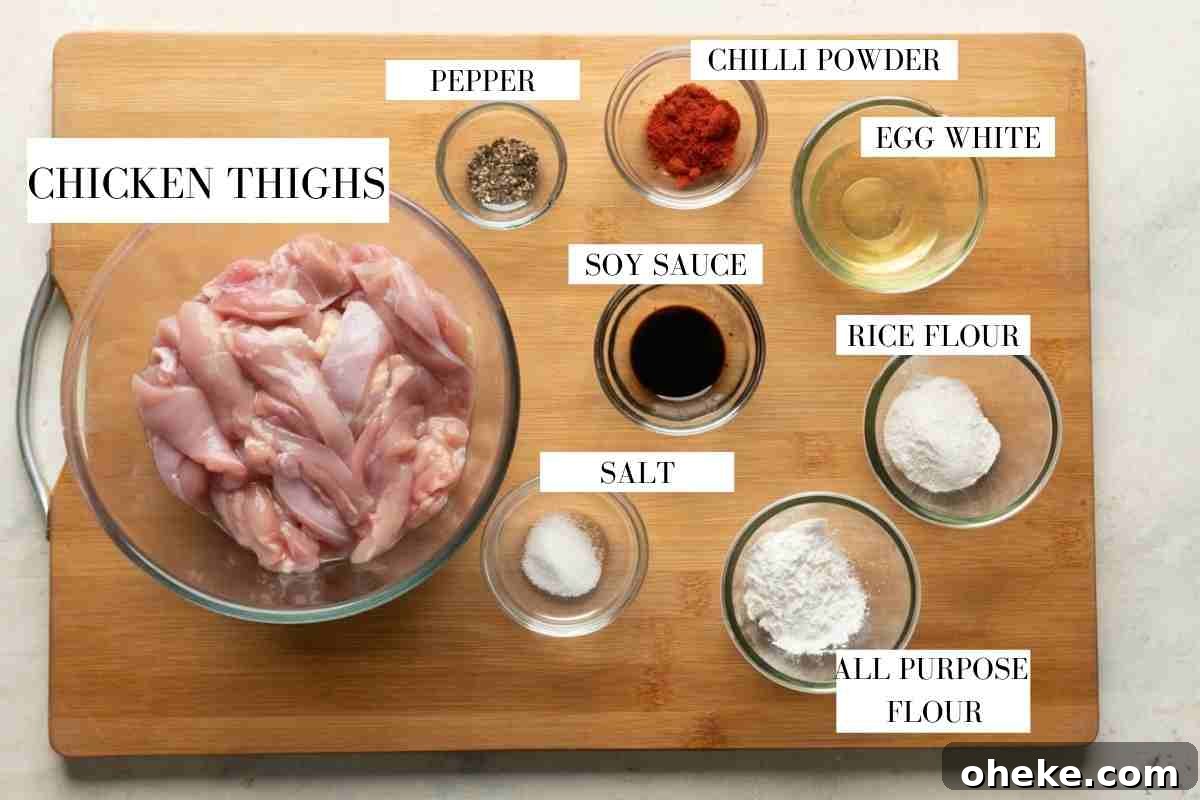 Ingredients for marinating and deep frying dragon chicken laid out with text to identify them